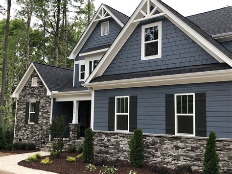 blue gray house with metal roof|gray house with dark trim.